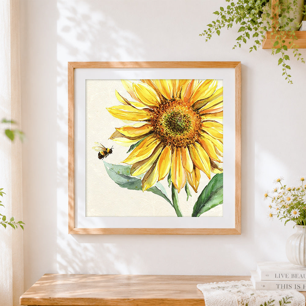 Finished a bee flying to a sunflower cross stitch artwork displayed