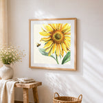 A bee flying to a sunflower cross stitch artwork displayed on wall as home decor