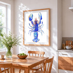 A blue lobster cross stitch artwork displayed on wall as home decor