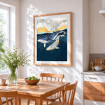 A pair of whales cross stitch artwork displayed on wall as home decor
