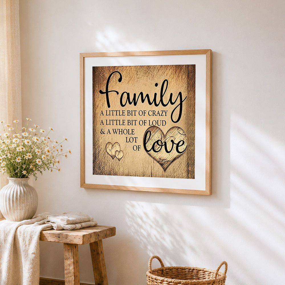 A sepia toned family quote cross stitch artwork displayed on wall as home decor