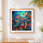 Finished abstract blue and orange floral swirls cross stitch artwork displayed