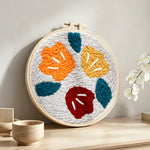 Abstract colourful flowers punch needle artwork displayed on a table