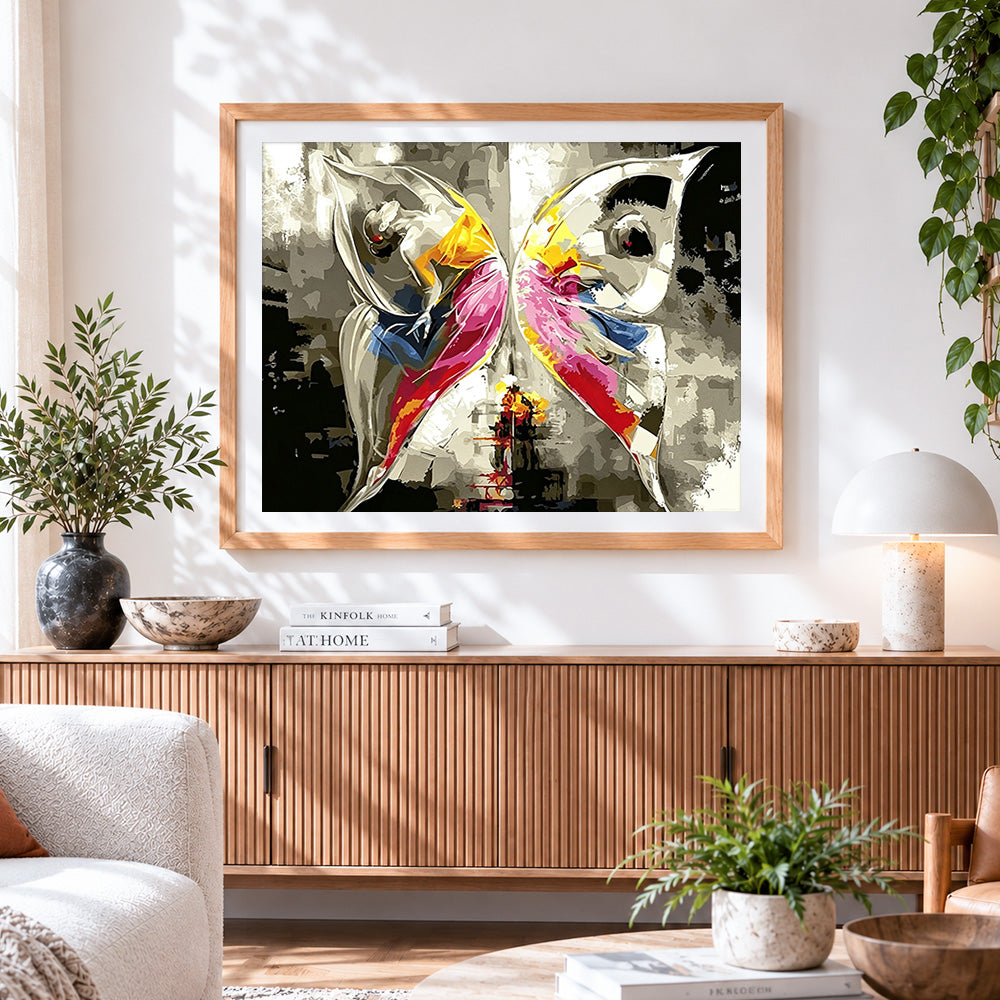 Finished abstract dancers in yellow and pink cross stitch artwork displayed