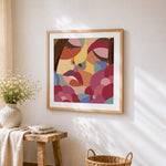 Abstract geometric face cross stitch artwork displayed on wall as home decor