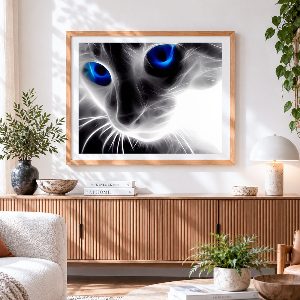 Finished abstract glowing blue eyes cat cross stitch artwork displayed