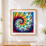 Finished abstract spiral kaleidoscope cross stitch artwork displayed