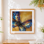Finished abstract splatter butterfly cross stitch artwork displayed