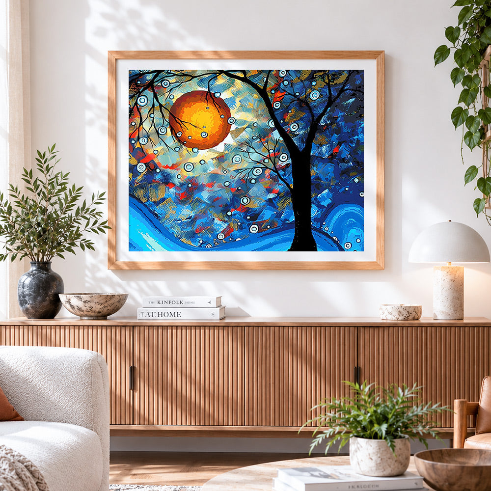 Finished abstract tree with orange sun cross stitch artwork displayed