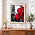 Finished acoustic guitar with red roses cross stitch artwork displayed