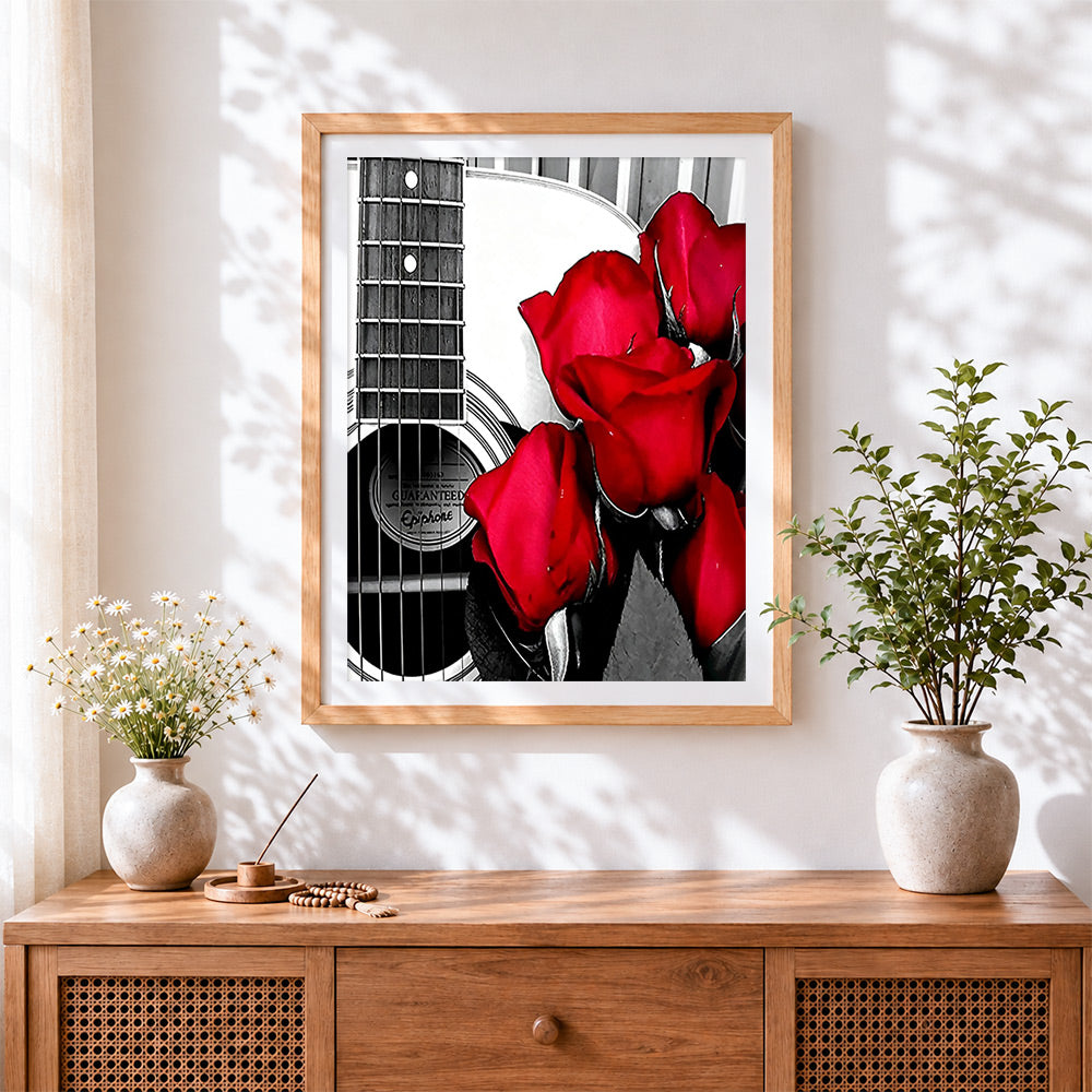 Finished acoustic guitar with red roses cross stitch artwork displayed