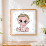 Finished adorable cartoon baby boy cross stitch artwork displayed