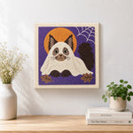 Finished adorable cat in ghost costume artwork displayed on a wall