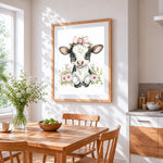 Adorable floral cow with pink bow cross stitch artwork displayed on wall as home decor