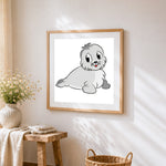 Adorable grey seal pup cross stitch artwork displayed on wall as home decor