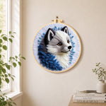 Adorable grey wolf needle felt wall art displayed in a bright home interior