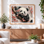 Finished adorable panda in cherry blossoms cross stitch artwork displayed