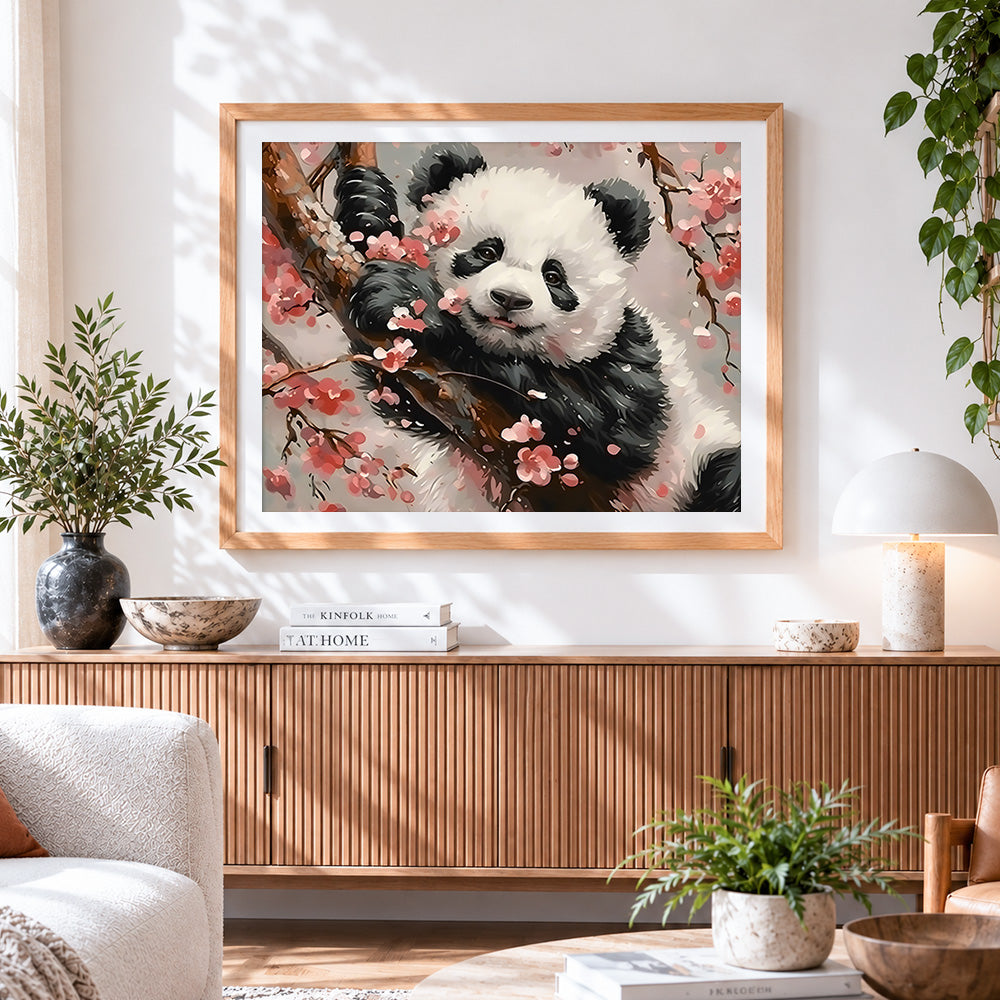 Finished adorable panda in cherry blossoms cross stitch artwork displayed