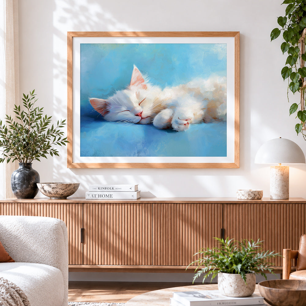 Finished adorable white cat sleeping cross stitch artwork displayed