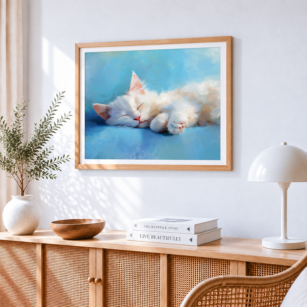 Adorable white cat sleeping cross stitch artwork displayed on wall as home decor