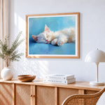 Adorable white cat sleeping cross stitch artwork displayed on wall as home decor