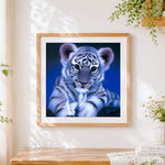 Finished adorable white tiger cub with butterflies cross stitch artwork displayed