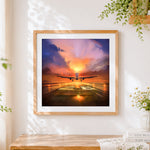 Finished aeroplane taking off at sunset cross stitch artwork displayed