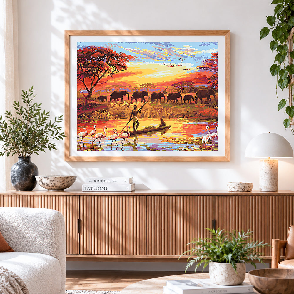 Finished african river canoes and elephant herds cross stitch artwork displayed