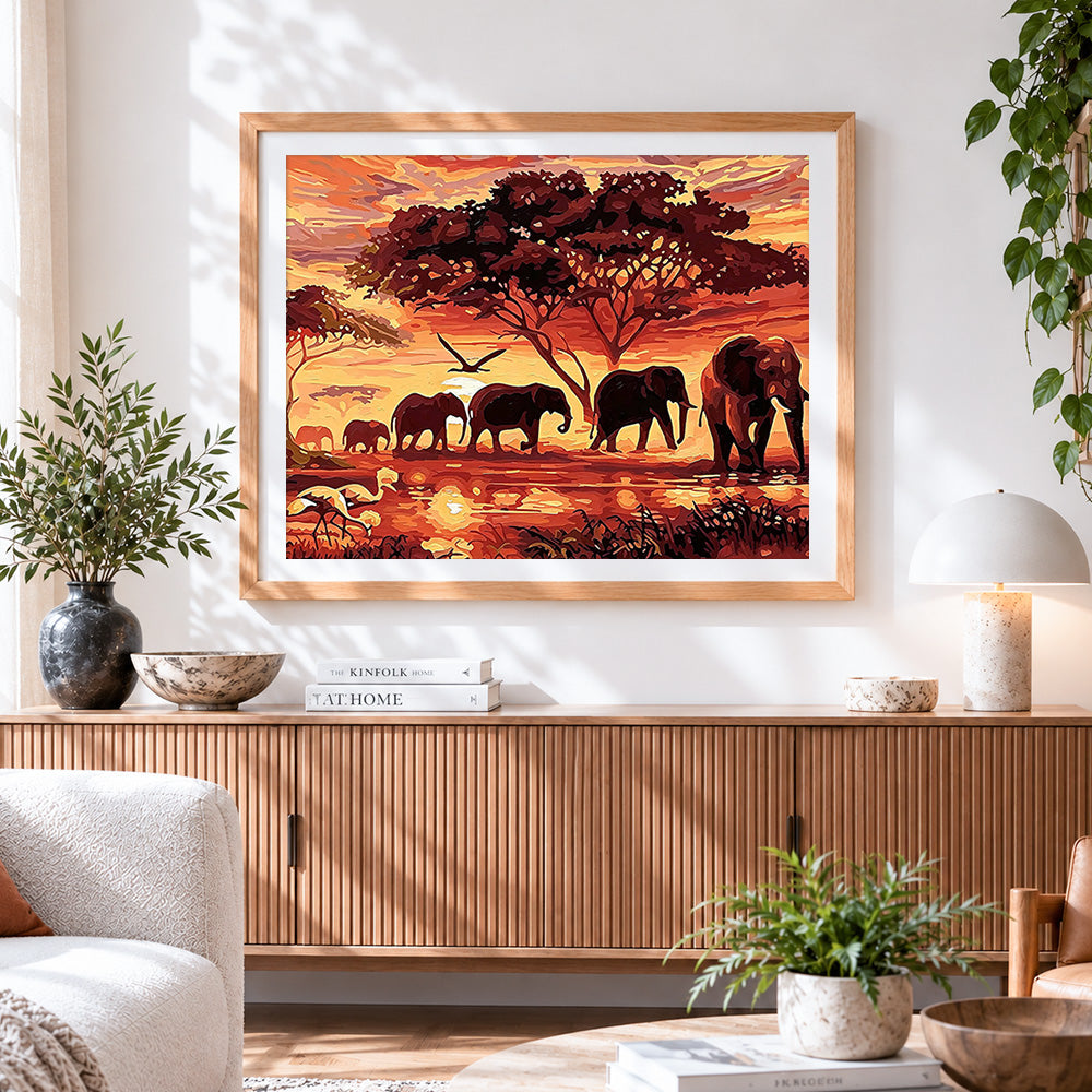 Finished african sunset elephant family cross stitch artwork displayed