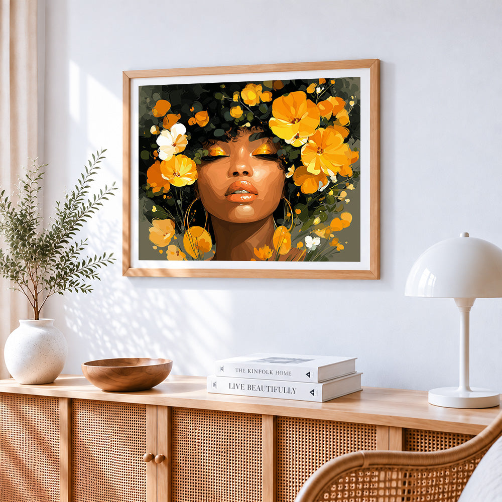 African woman and golden flowers cross stitch artwork displayed on wall as home decor