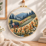 Alpine wildflower slopes embroidery hoop wall art displayed as warm and cozy handmade home decor