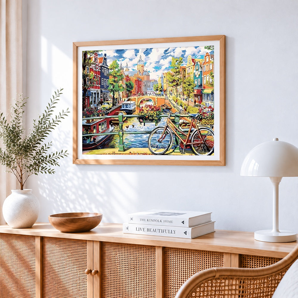 Amsterdam canal and bicycle cross stitch artwork displayed on wall as home decor