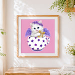 Finished angel cat with wings and harp cross stitch artwork displayed