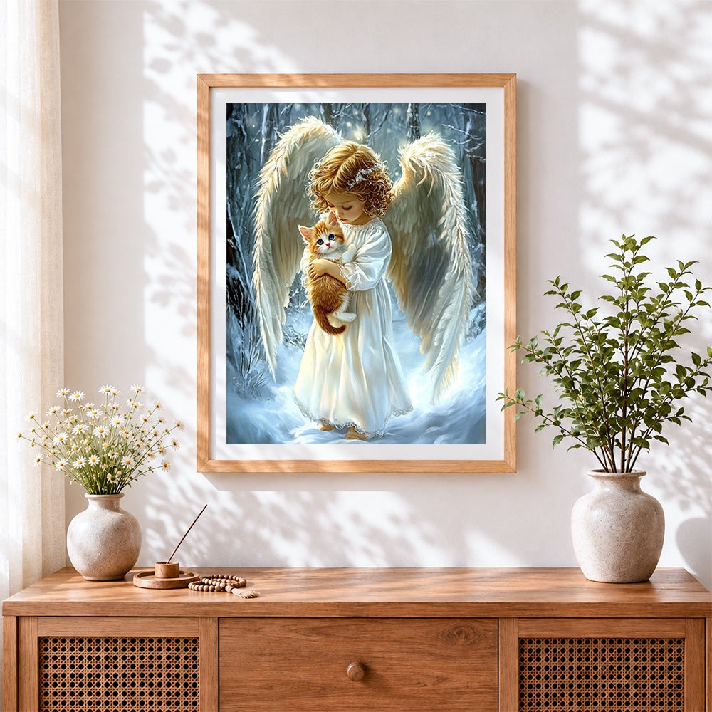Finished angel holding a kitten in the snow cross stitch artwork displayed