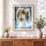 Finished angel holding a kitten in the snow cross stitch artwork displayed