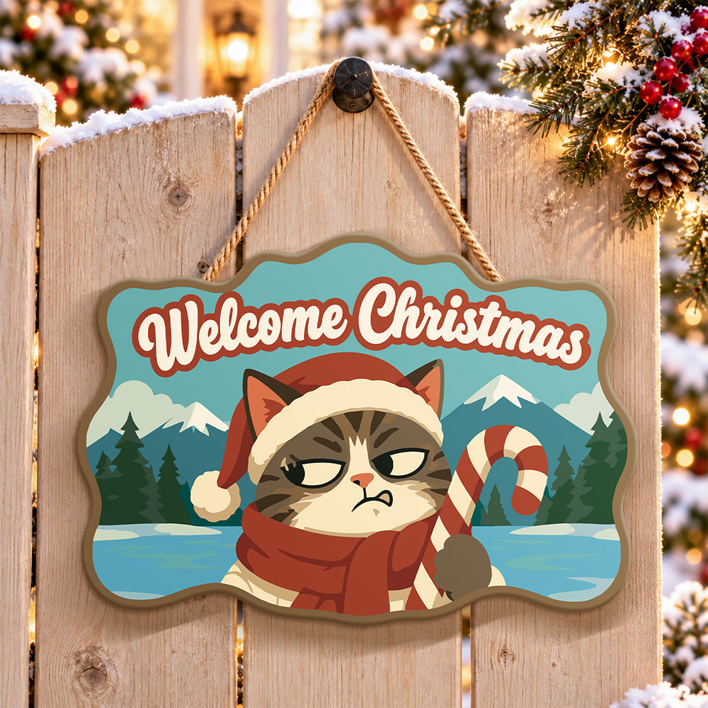 Annoyed cat with candy cane paint by numbers door hanger on a garden gate