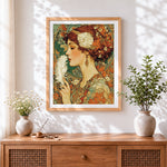 Finished art nouveau woman with white feather cross stitch artwork displayed