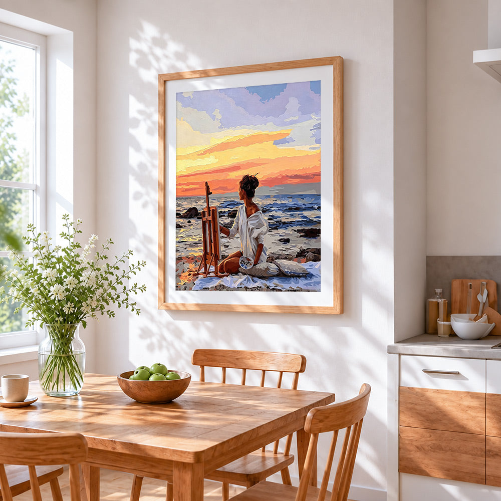 Artist painting on beach cross stitch artwork displayed on wall as home decor