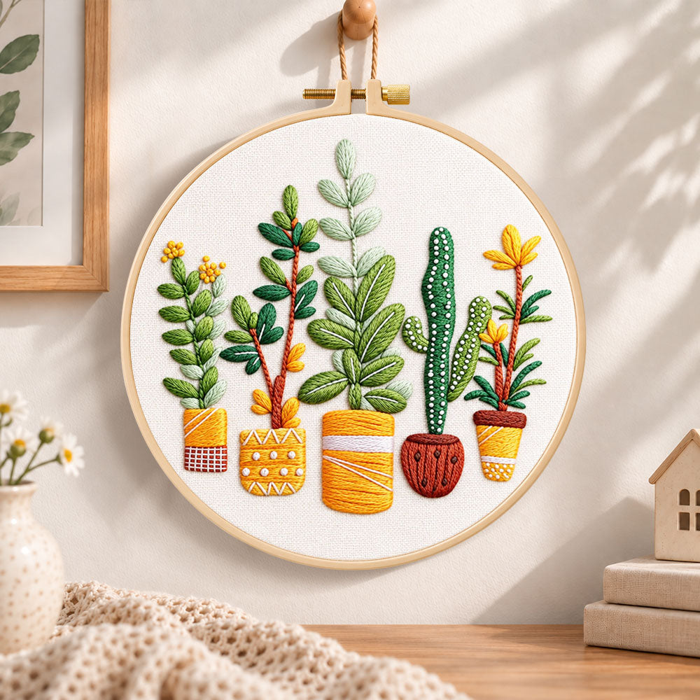 Assorted houseplants embroidery hoop wall art displayed as warm and cosy handmade home decor
