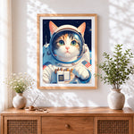 Finished astronaut cat in space suit cross stitch artwork displayed