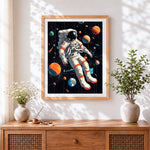 Finished astronaut floating among planets cross stitch artwork displayed