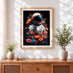Finished astronaut surrounded by flowers cross stitch artwork displayed