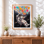 Finished astronaut with colourful balloons cross stitch artwork displayed