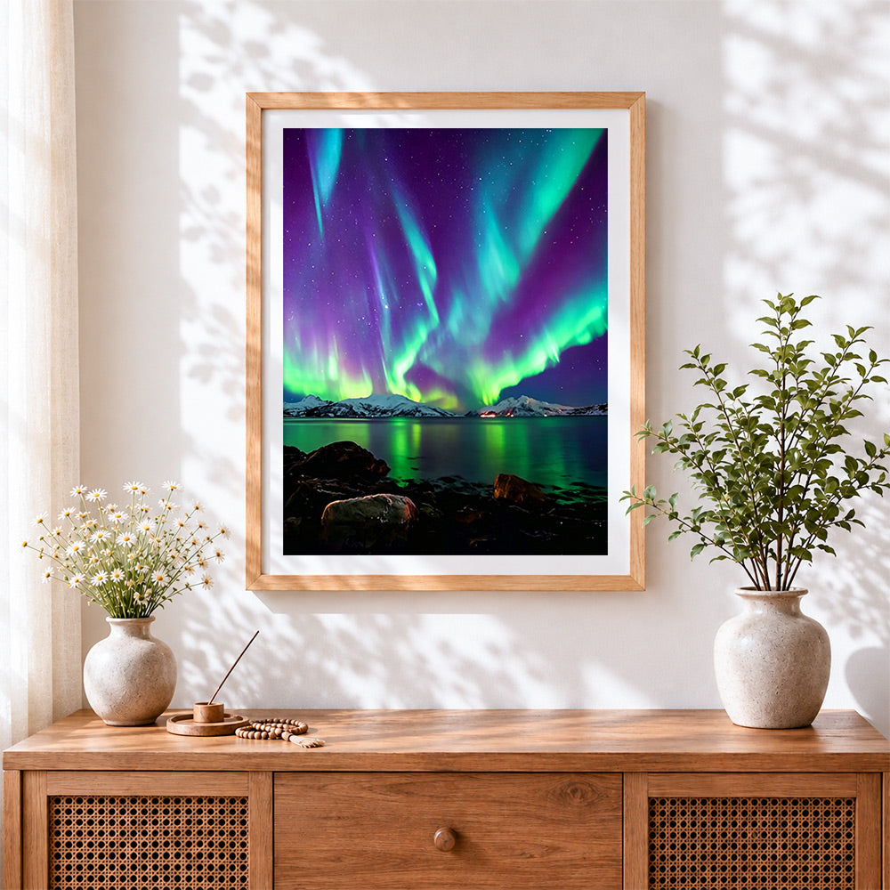 Finished aurora borealis over snowy mountains cross stitch artwork displayed