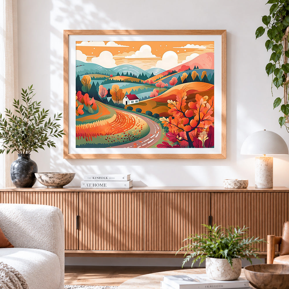 Finished autumn cottage and winding road cross stitch artwork displayed