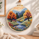 Autumn creek and trees embroidery hoop wall art displayed as warm and cozy handmade home decor