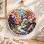 Autumn forest stream embroidery hoop wall art displayed as warm and cozy handmade home decor