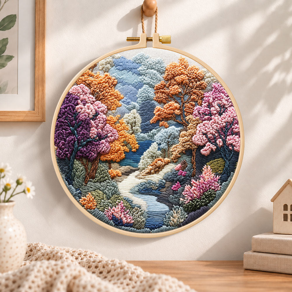 Autumn forest stream embroidery hoop wall art displayed as warm and cozy handmade home decor