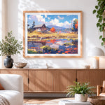 Finished autumn lake cabin cross stitch artwork displayed