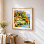 Autumn lake cottage with swans cross stitch artwork displayed on wall as home decor